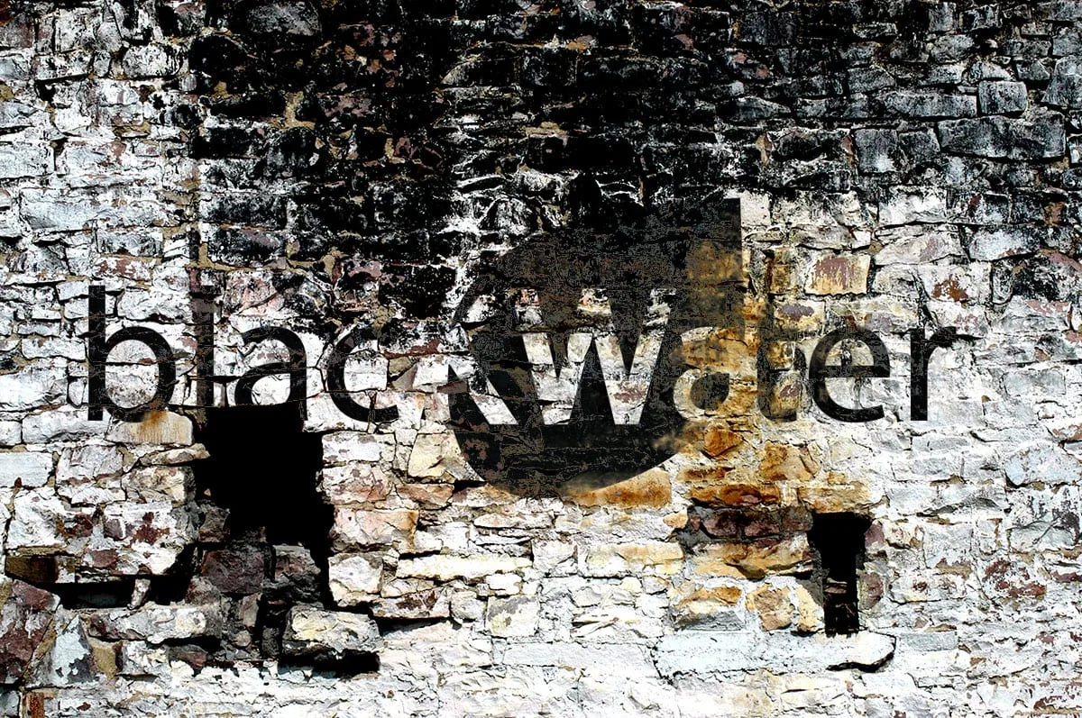 blackWater logo stenciled onto a textured stone wall