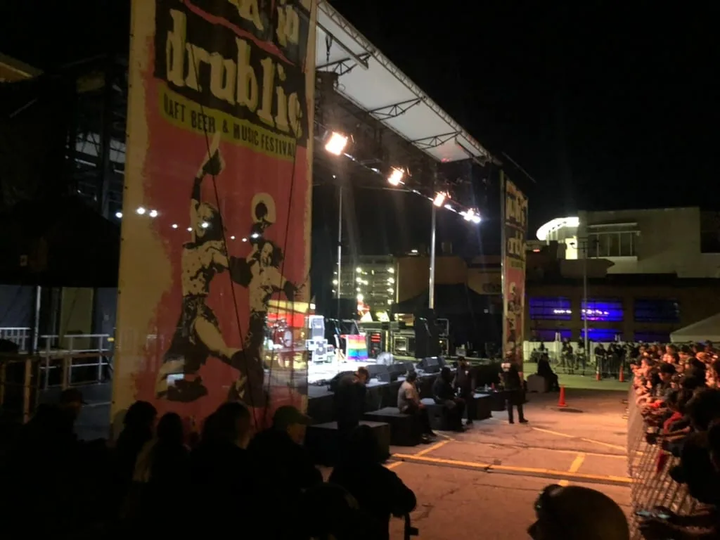Punk in Drublic craft beer and music festival stage with security staff and crowd barricades at night